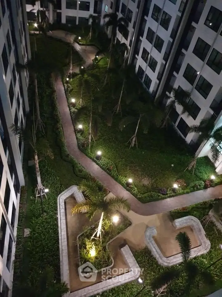 Stunning night view of a beautifully landscaped garden in a modern apartment complex.