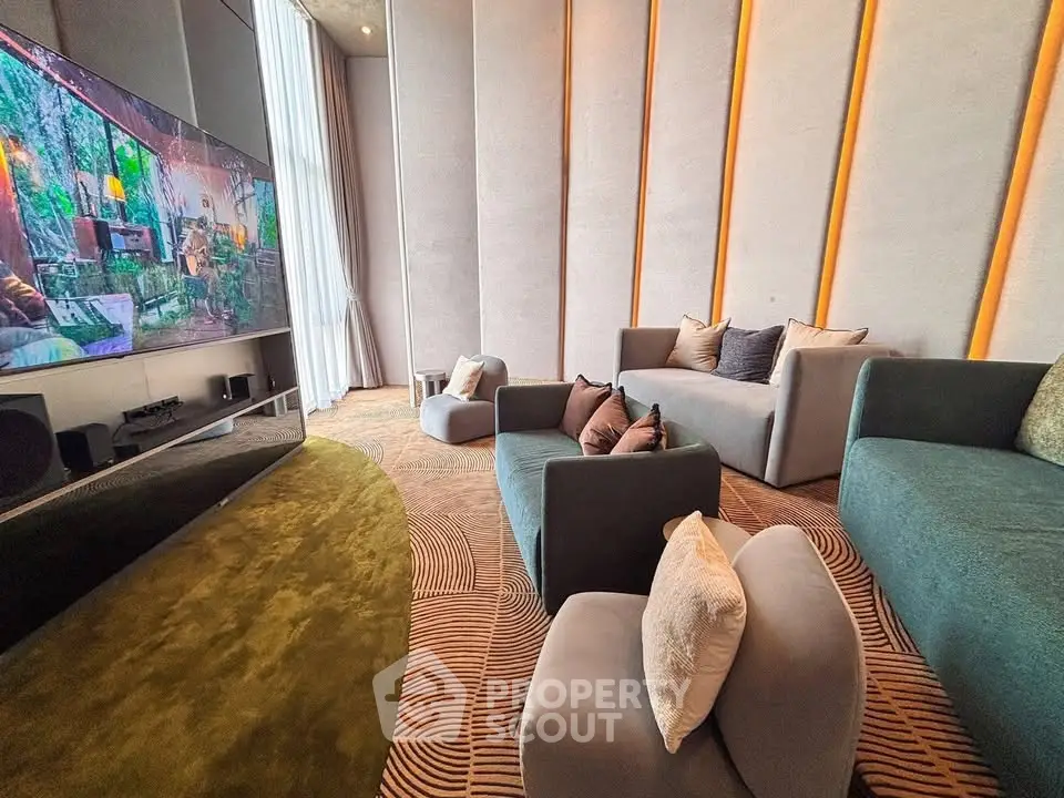 Luxurious modern living room with plush seating and large TV, perfect for entertainment and relaxation.