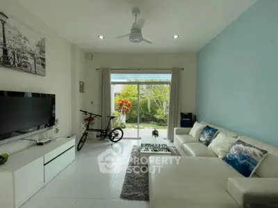 Modern living room with garden view, white sofa, and stylish decor