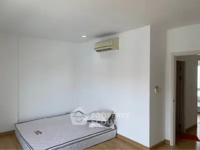 Minimalist bedroom with mattress and air conditioning in modern apartment