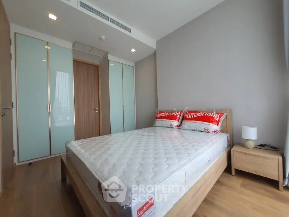 Modern bedroom with wooden flooring and minimalist design