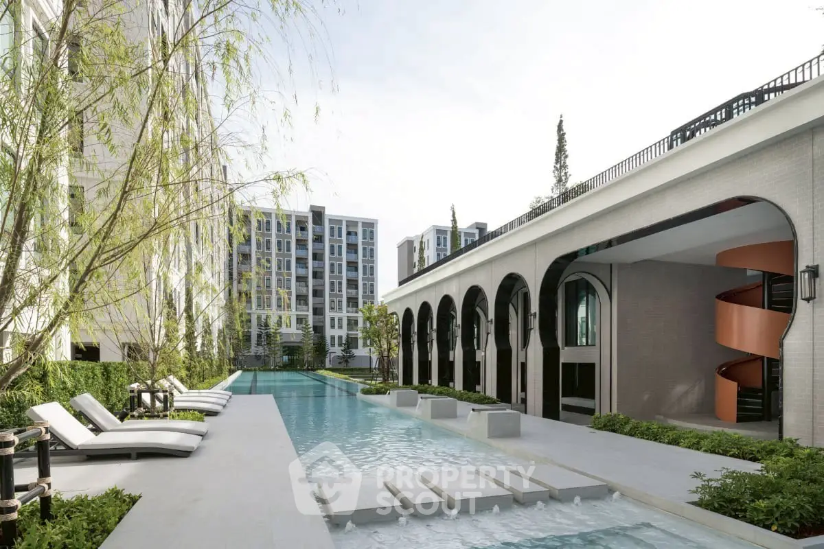Luxurious modern apartment complex with stunning pool and elegant architecture.