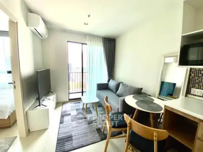 Modern living room with stylish furniture and balcony view in a contemporary apartment.