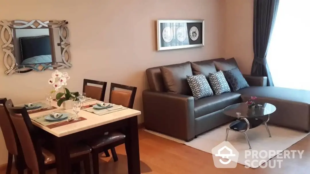 Inviting and well-appointed living room with comfortable leather sofa, elegant dining set, and tasteful wall decor, perfect for relaxation and entertaining guests.