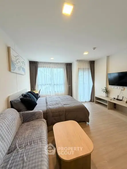 Modern studio apartment with cozy living area and natural light