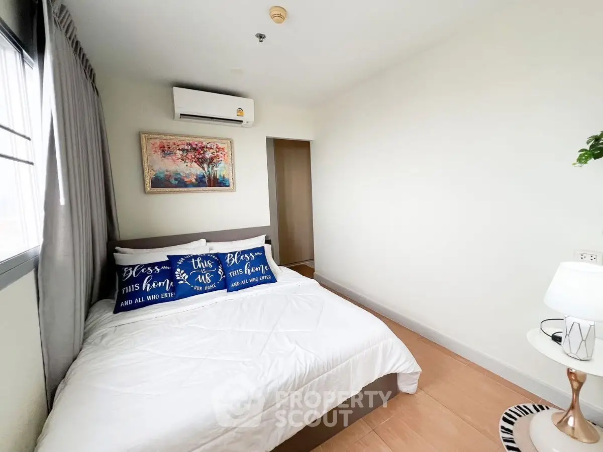 Cozy bedroom with modern decor and air conditioning in a bright apartment.