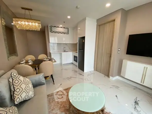 Modern living room with elegant dining area and stylish kitchen in open layout.