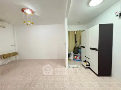 Spacious unfurnished room with tiled flooring and modern lighting, ideal for customization.