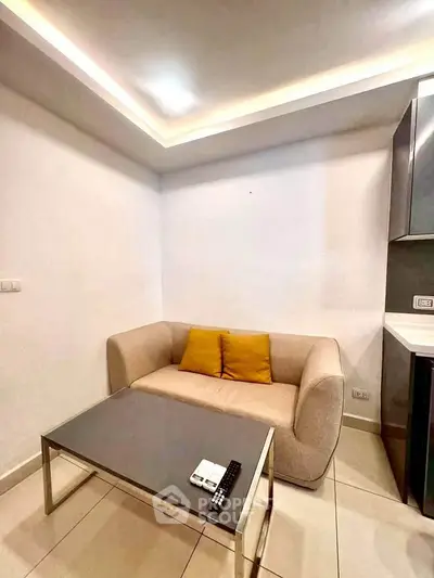 Cozy living room with modern sofa and sleek coffee table, perfect for relaxation.