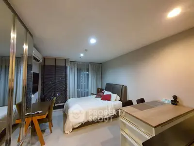 Modern bedroom with stylish decor and mirrored wardrobe in cozy apartment.