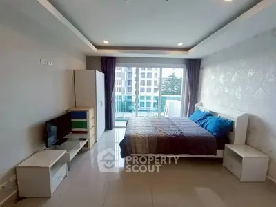 Spacious bedroom with balcony and modern decor in urban apartment