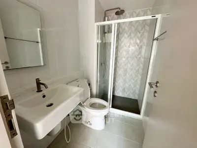 Modern bathroom with sleek fixtures and glass shower enclosure