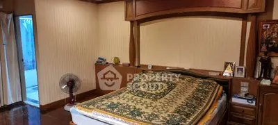 Spacious bedroom with elegant wooden decor and cozy ambiance