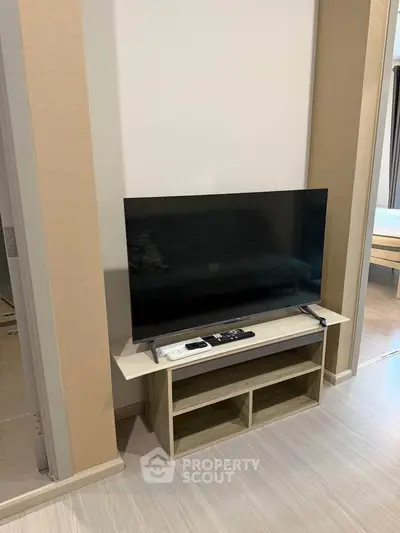 Modern living room with sleek TV setup and stylish flooring