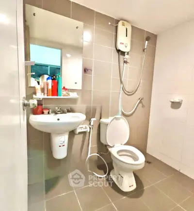 Modern bathroom with sleek fixtures and wall-mounted shower in a contemporary apartment.
