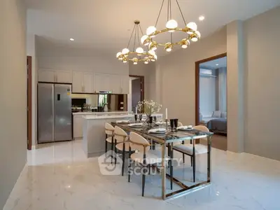 Luxurious dining area with elegant chandelier and modern kitchen in open layout apartment.