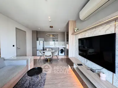 Modern open-plan living room with sleek kitchen and stylish decor