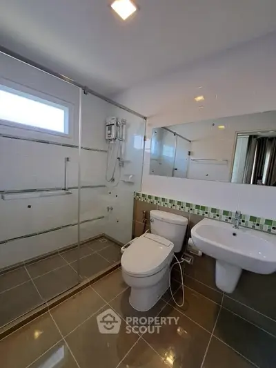 Modern bathroom with glass shower and sleek fixtures