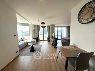 Spacious modern living room with city view, stylish decor, and open layout in a high-rise apartment.