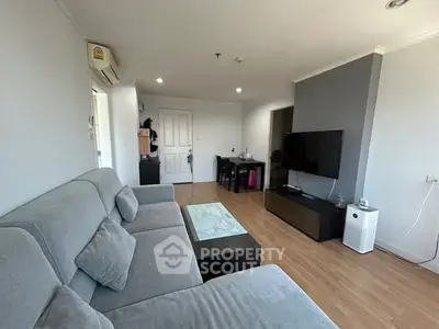 Modern living room with sleek furniture and wall-mounted TV