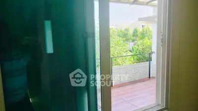 Charming balcony view with lush greenery and modern railing design.