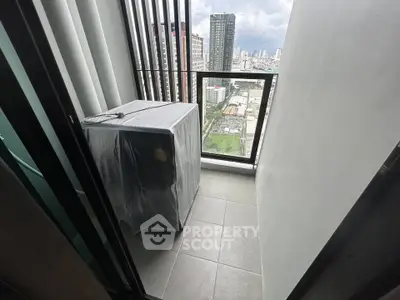 Compact balcony with city view and covered appliance, ideal for urban living.
