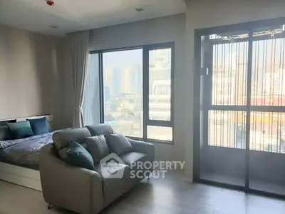 Modern bedroom with city view and cozy seating area