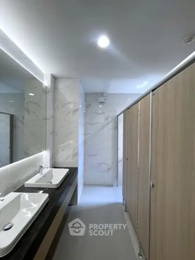 Modern public bathroom with sleek design and dual sinks