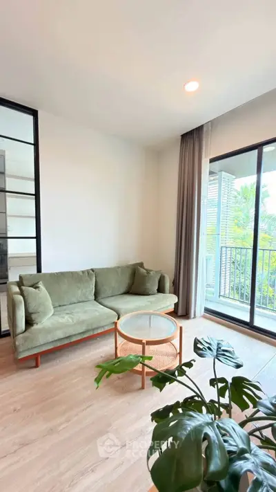 Modern living room with green sofa and balcony view