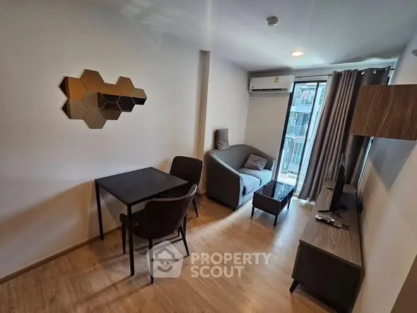 Modern living room with stylish decor and balcony access in a cozy apartment.