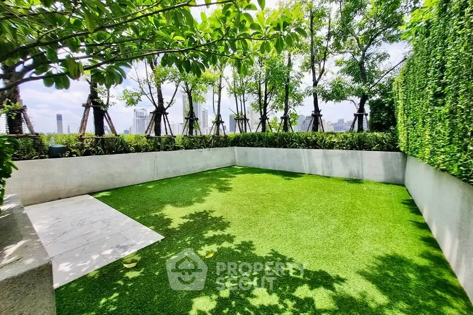 Lush green garden area with city views, perfect for relaxation and outdoor activities.