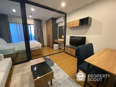 Modern apartment interior with cozy living room and bedroom, featuring wooden furniture and large windows.