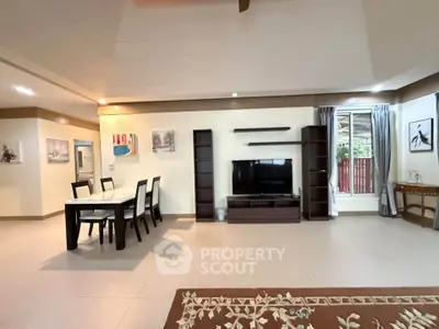 Spacious living room with modern decor and dining area, perfect for family gatherings.