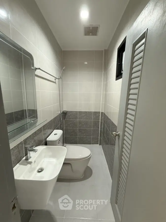 Modern bathroom with sleek fixtures and neutral tile design