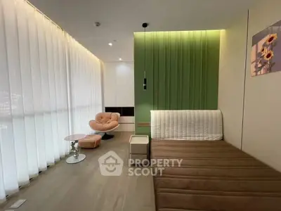 Modern living room with stylish furniture and floor-to-ceiling windows for natural light.