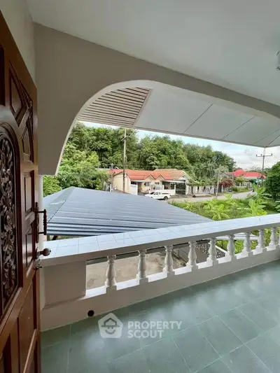 Charming balcony with scenic neighborhood view and lush greenery