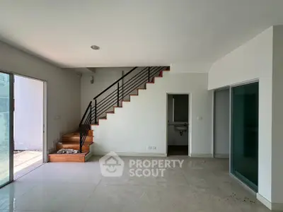 Modern interior with sleek staircase and open layout, perfect for stylish living.