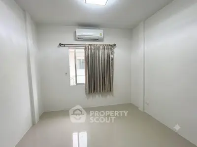 Minimalist empty room with air conditioning and window curtain, perfect for customization.