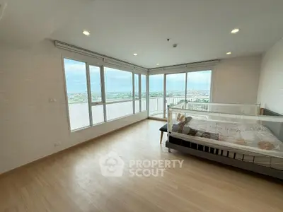 Spacious bedroom with panoramic city view and large windows
