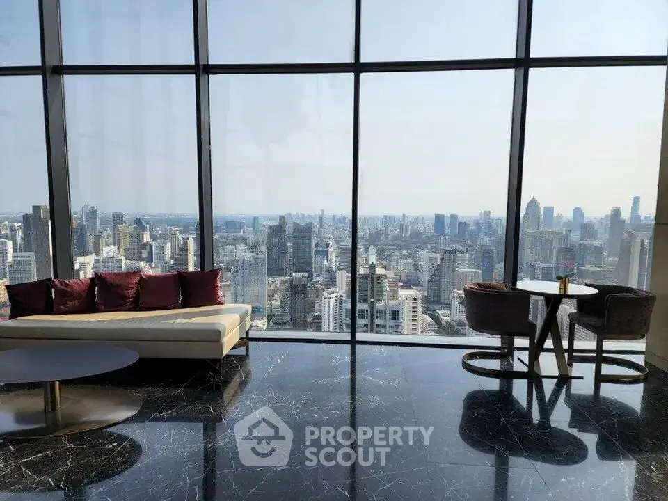 Luxurious high-rise living room with panoramic city skyline view and elegant furnishings.