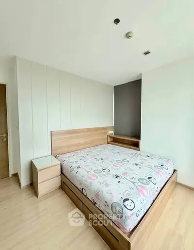 Spacious bedroom with modern wooden furniture and ample natural light