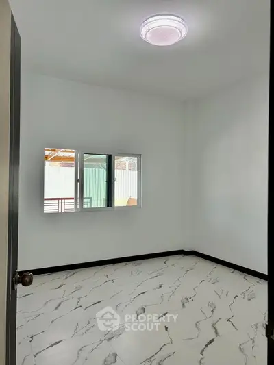 Spacious empty room with marble flooring and modern lighting, perfect for customization.