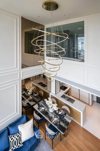 Luxurious duplex living room with elegant chandelier and modern dining area