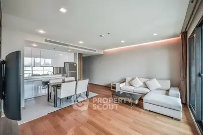 Spacious modern living room with open kitchen and elegant wooden flooring