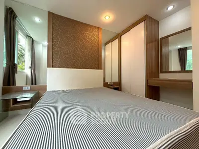 Modern bedroom with stylish decor and ample natural light