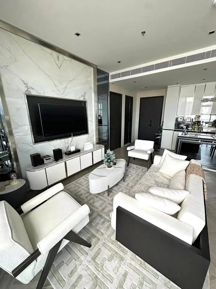Luxurious modern living room with elegant furniture and open kitchen layout
