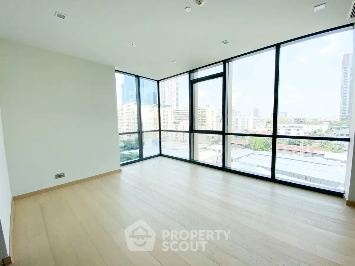 Spacious corner unit with floor-to-ceiling windows offering stunning city views and abundant natural light.