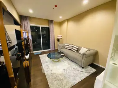 Stylish living room with plush sofa and modern decor in a cozy apartment setting.