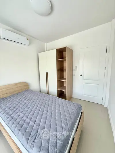Bright and cozy bedroom with modern furnishings and ample storage space.