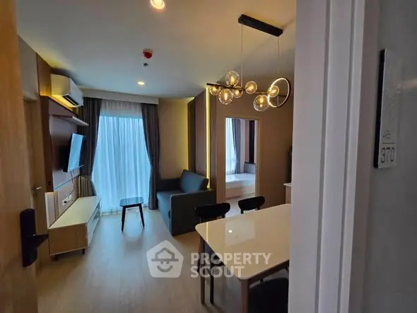 Modern living room with stylish lighting and cozy furniture in a contemporary apartment.